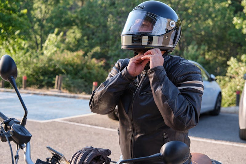A man putting helmet on his head