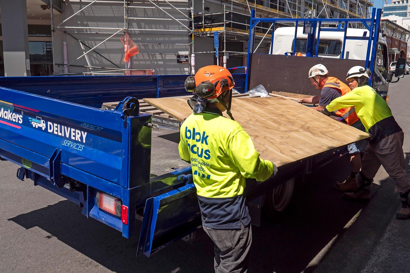 Construction workers loading FUSO eCanter tipper from Keith Andrews.