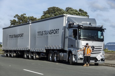 Richie Belvie next to a 6x4 Mercedes-Benz Actros Curtainsider from Keith Andrews.