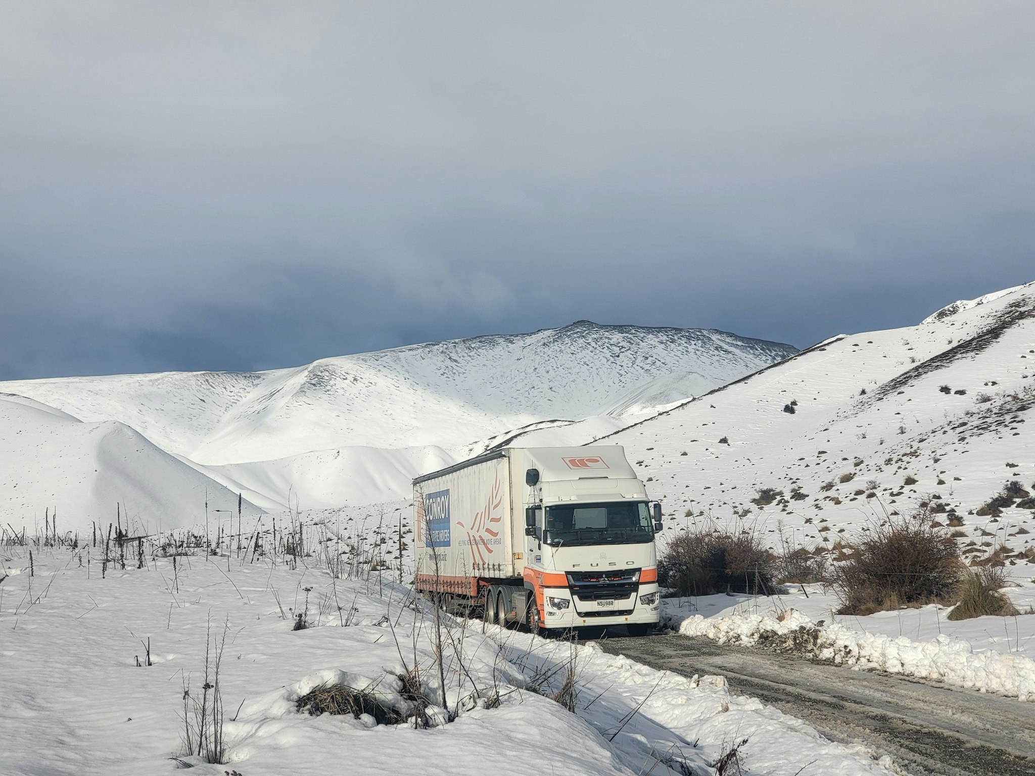 Conroy Removals' FUSO Shogun 6x4 curtainsider from Keith Andrews in snow.