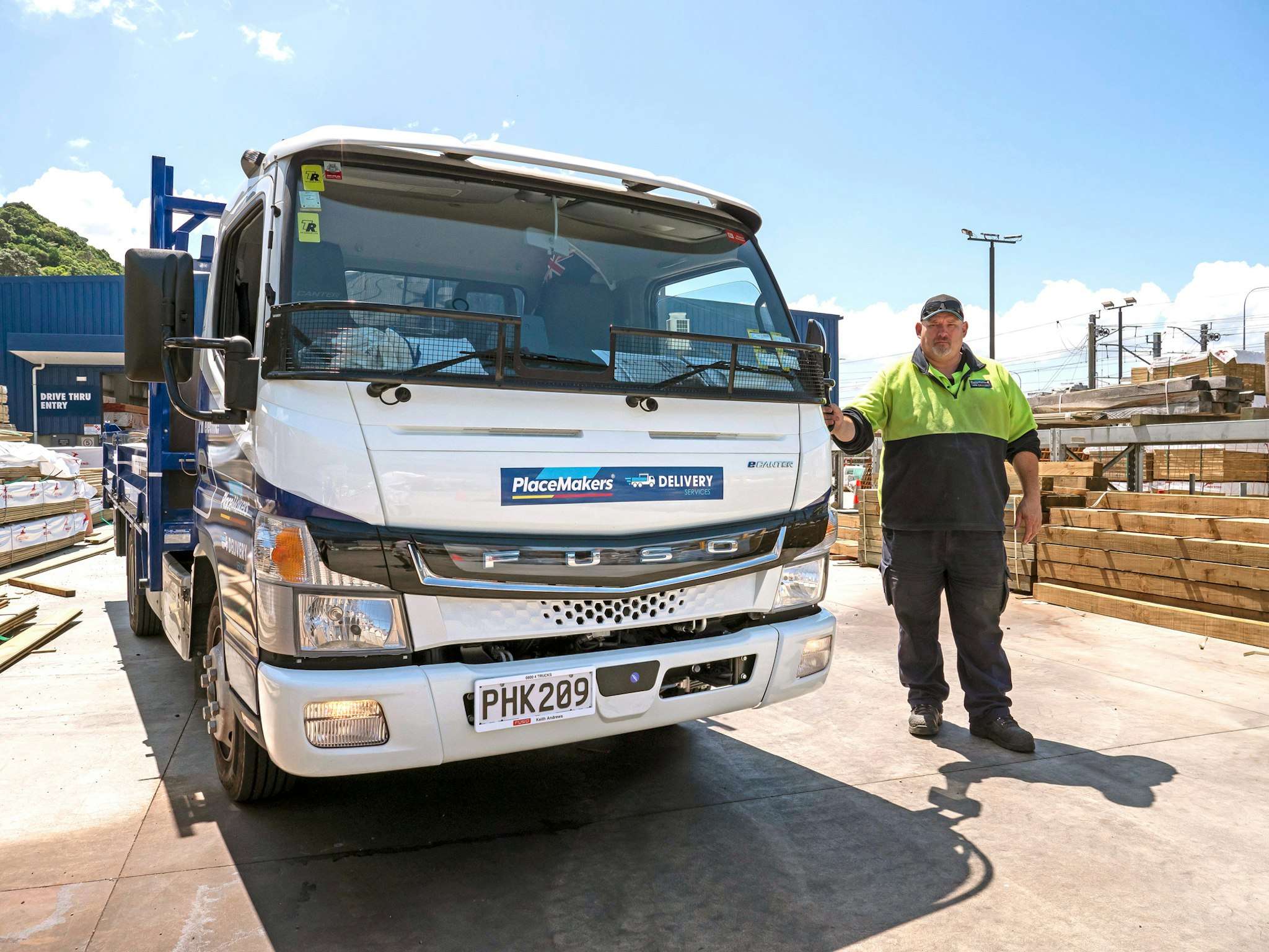 Jason Fisk of PlaceMakers beside FUSO eCanter tipper from Keith Andrews.