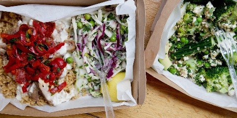 Carboard square dishes with food in them