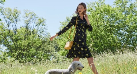 Women in dress with dog and grass and trees