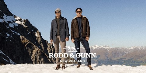 Men standing on snow in front of mountains