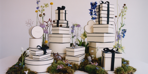 Pile of white gift boxes and black ribbons