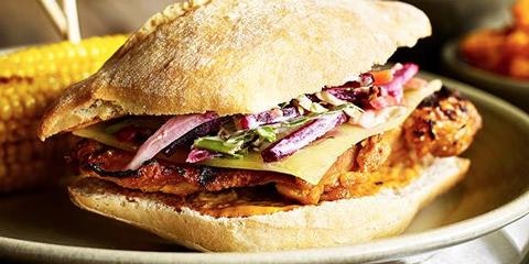 Chicken burger with cheese and salad on a plate