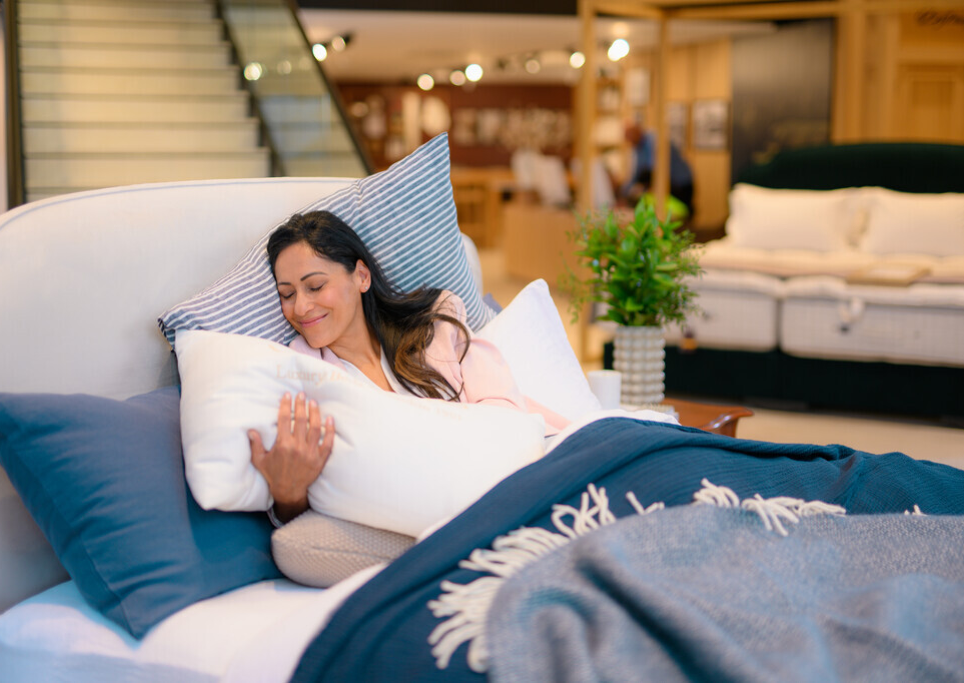 Woman in bed with pillow and blanket