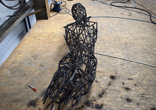 Wire statue for Christmas lights on a wooden floor