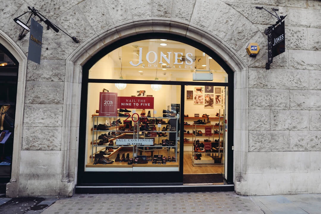 Shelfs of shoes through a window