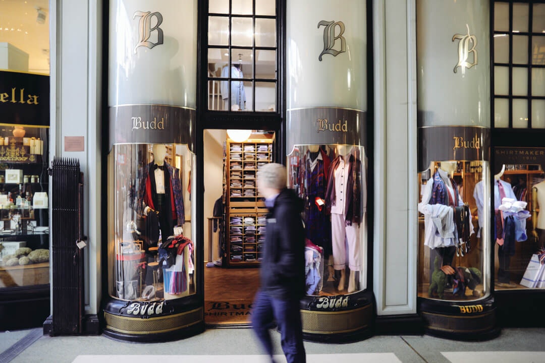 Man walking past front of shop