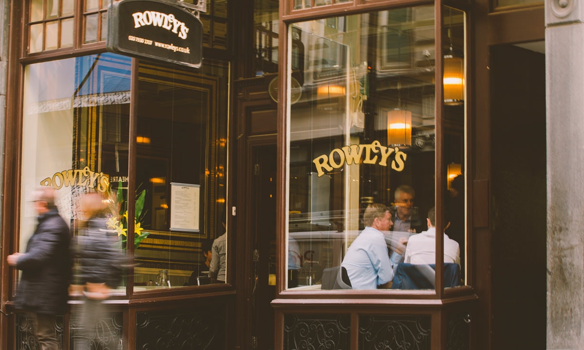 People at table through window