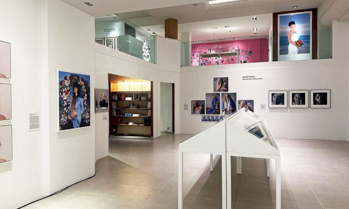 Inside a gallery, white with pictures