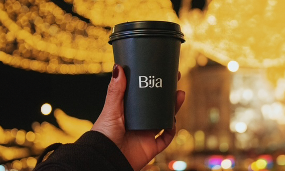 Hand with black takeaway cup
