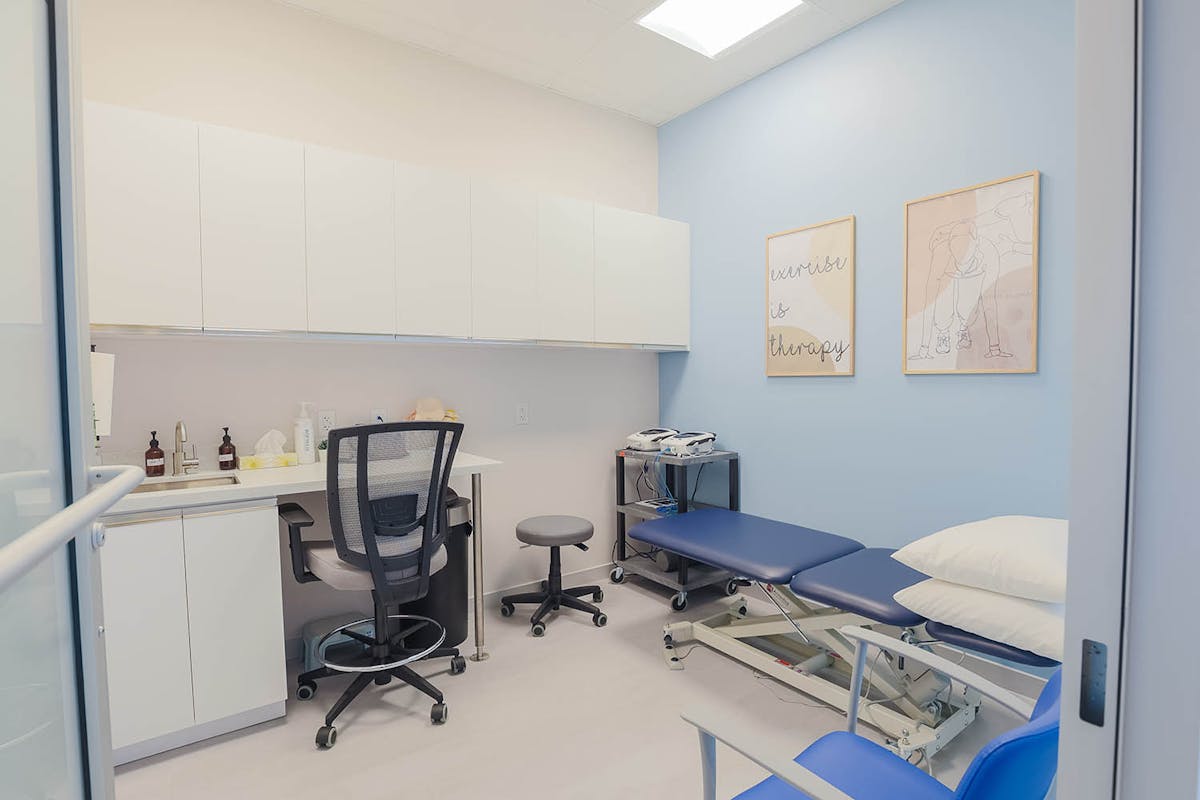 Therapist assisting older adult with balance exercise