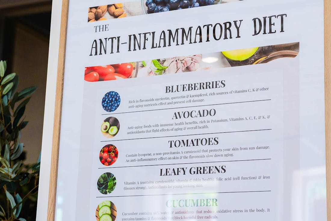 Person enjoying a healthy drink in a bright café setting