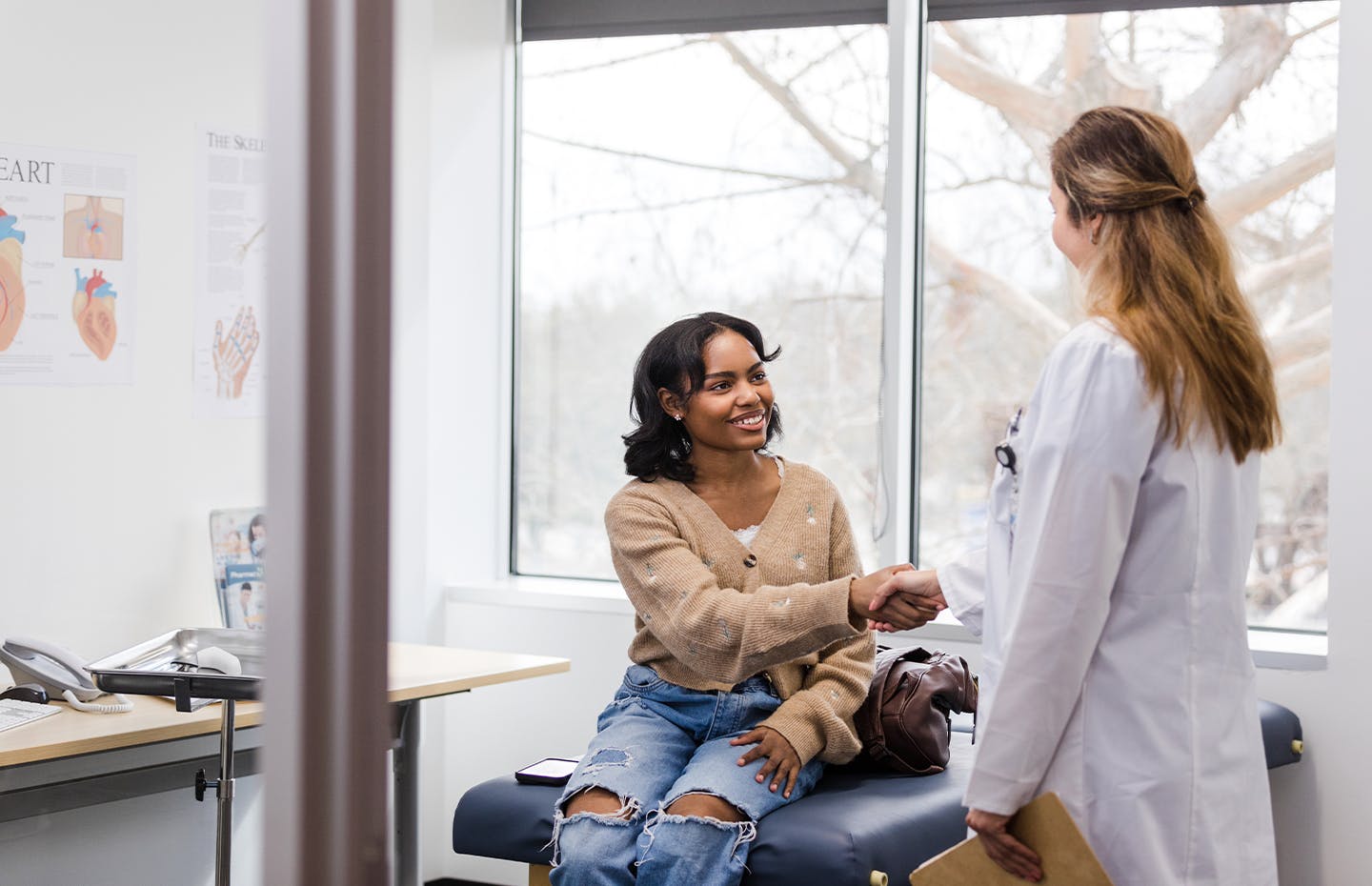 female patient shaking doctors hand