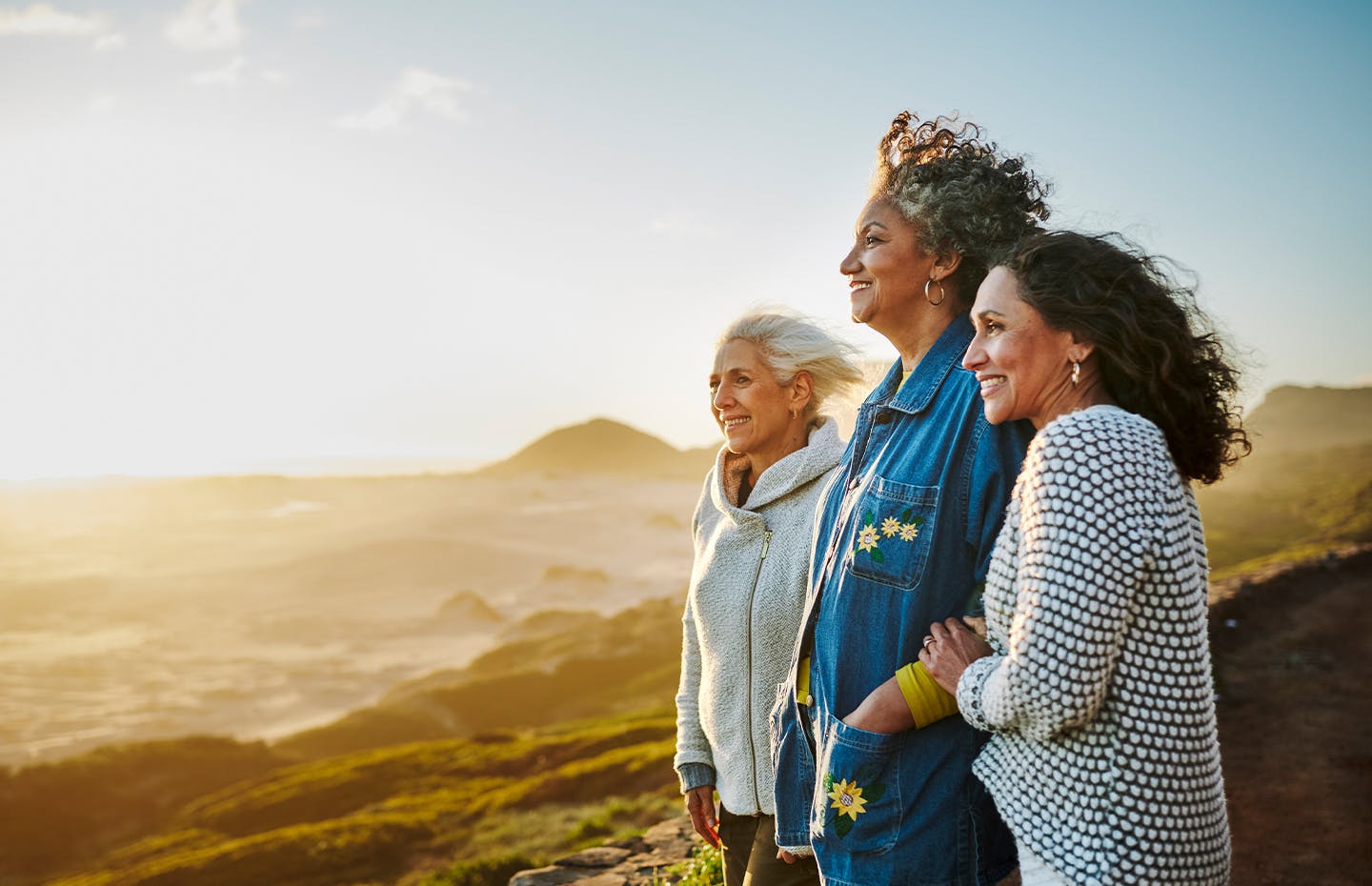 group of woman looking at the sunset during a hike