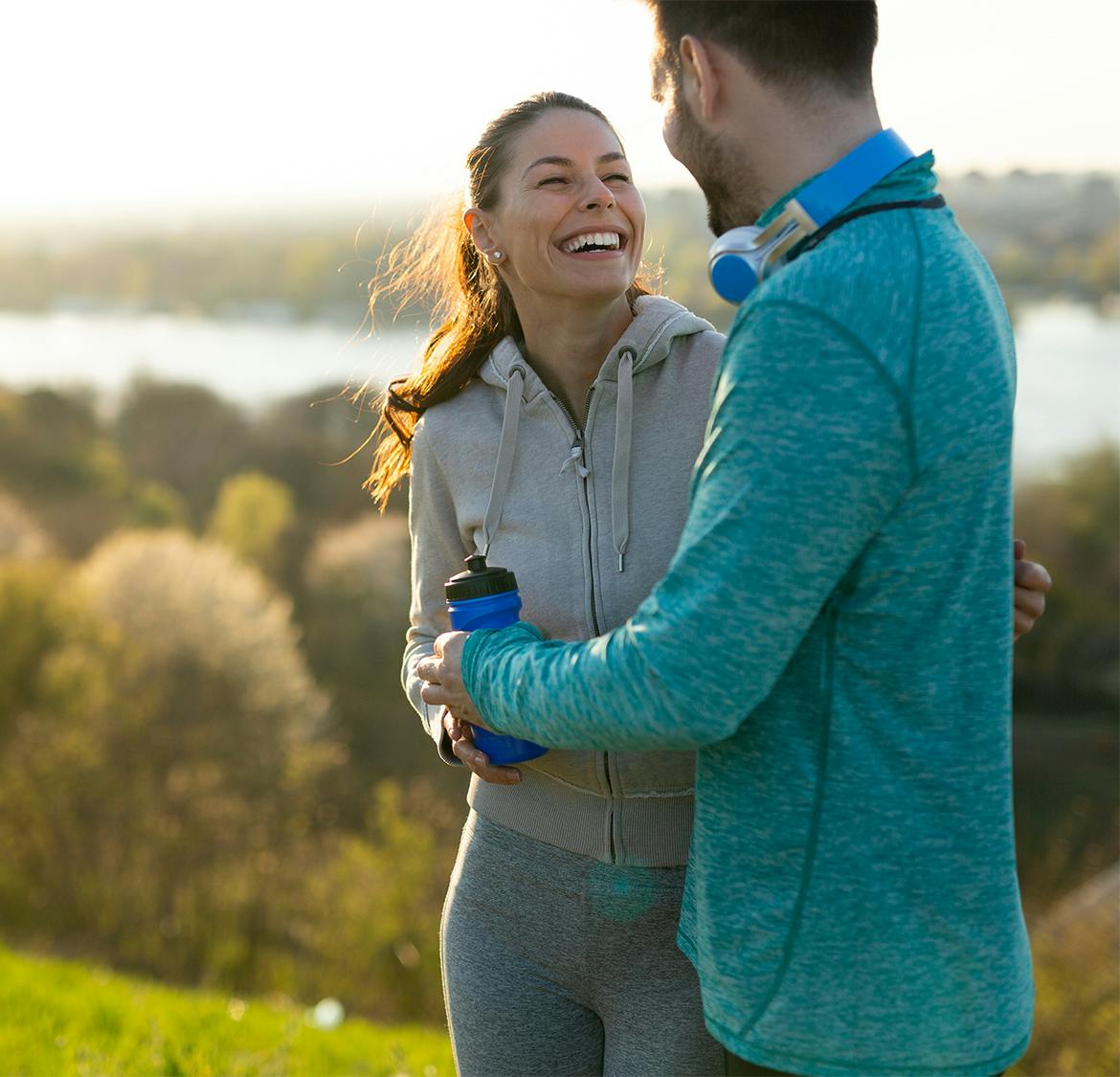 couple smiling while on a hike