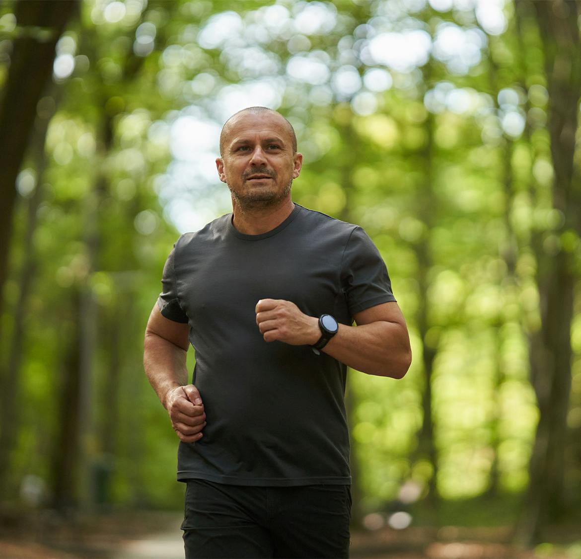 man running between a lot of trees