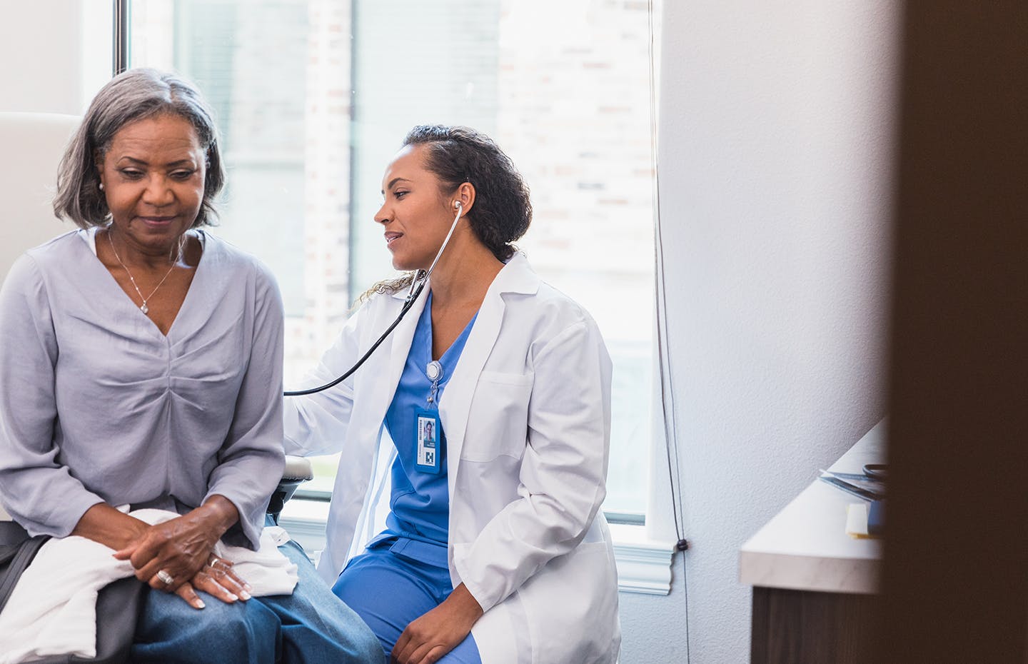 doctor listening to patient's heart