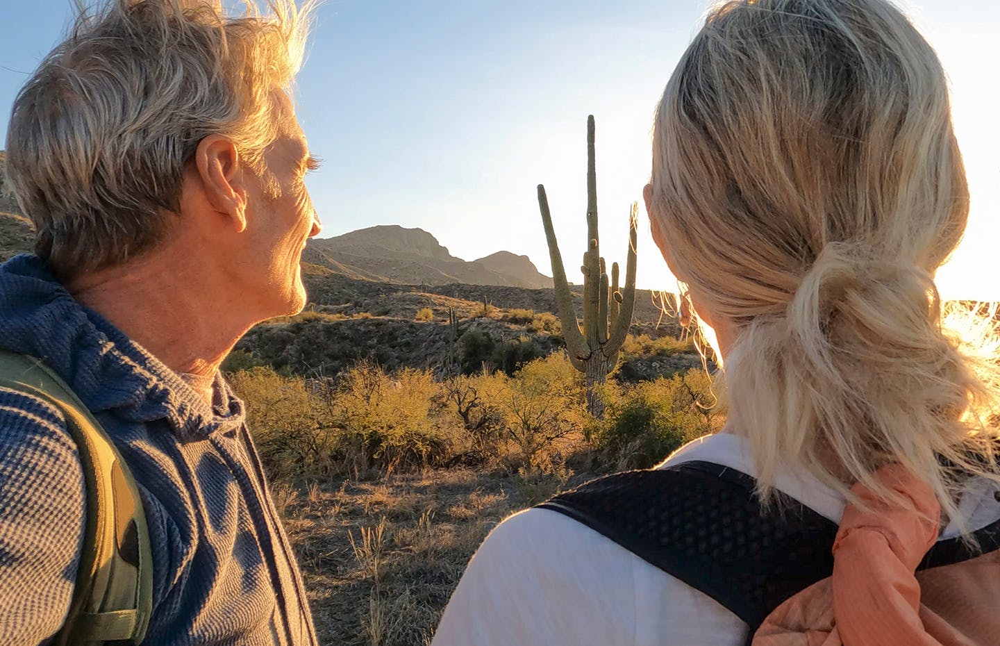 male and female looking at cactus