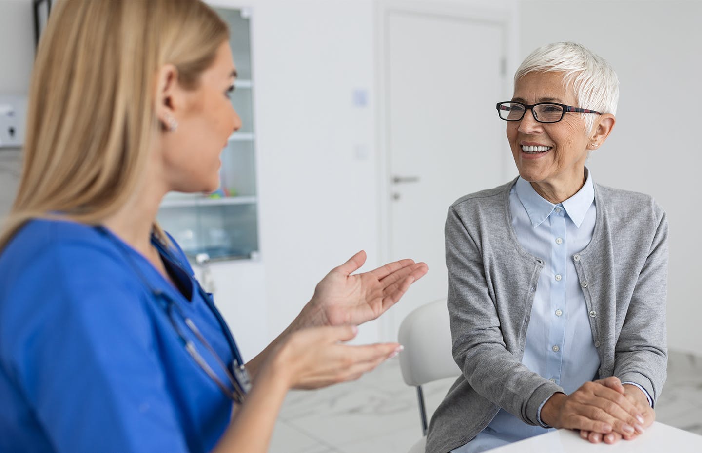 2 women speaking together and smiling