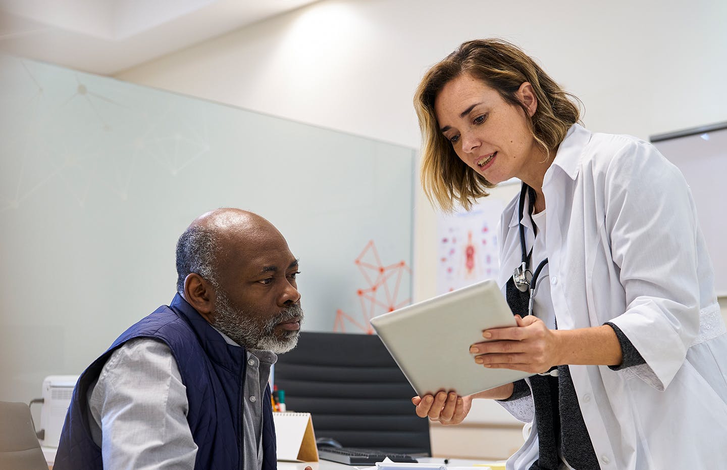 doctor showing patient something on the ipad