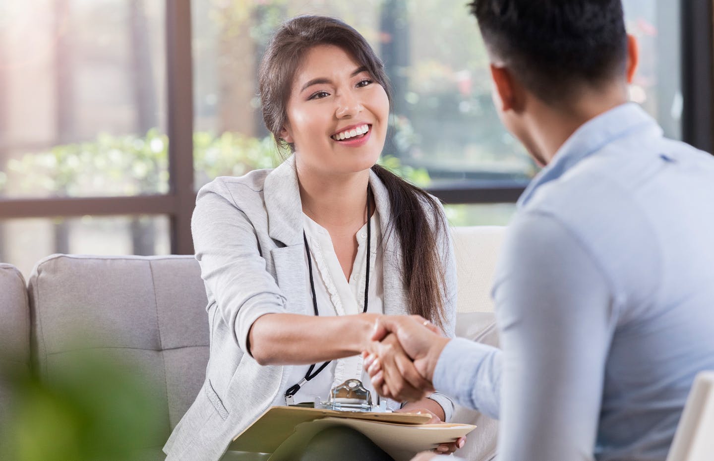 staff shaking patient's hand and smiling