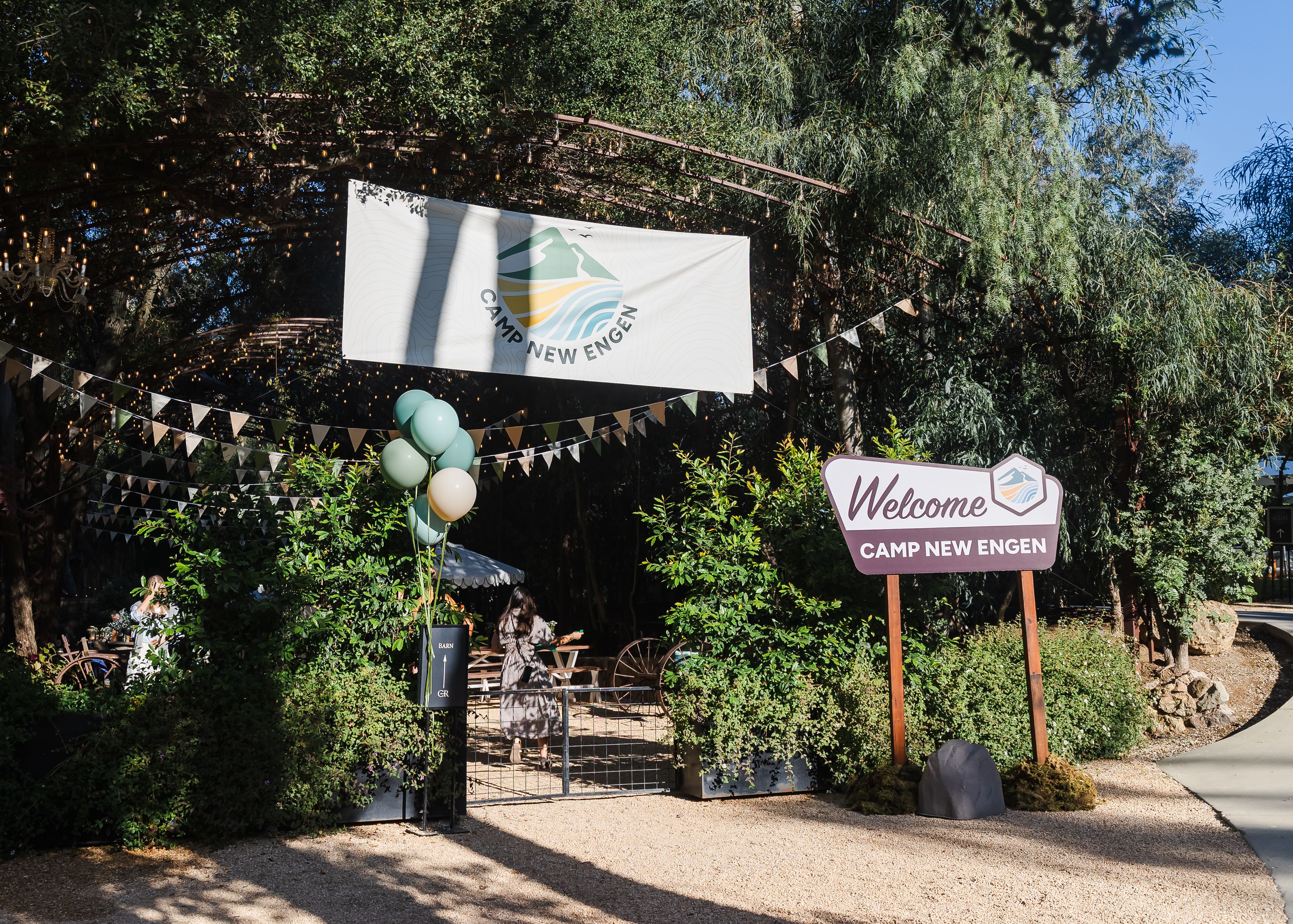 Welcome sign and Camp New Engen 2026 banner at the outdoor entrance to the marketing summit at Calamigos Ranch in Malibu.