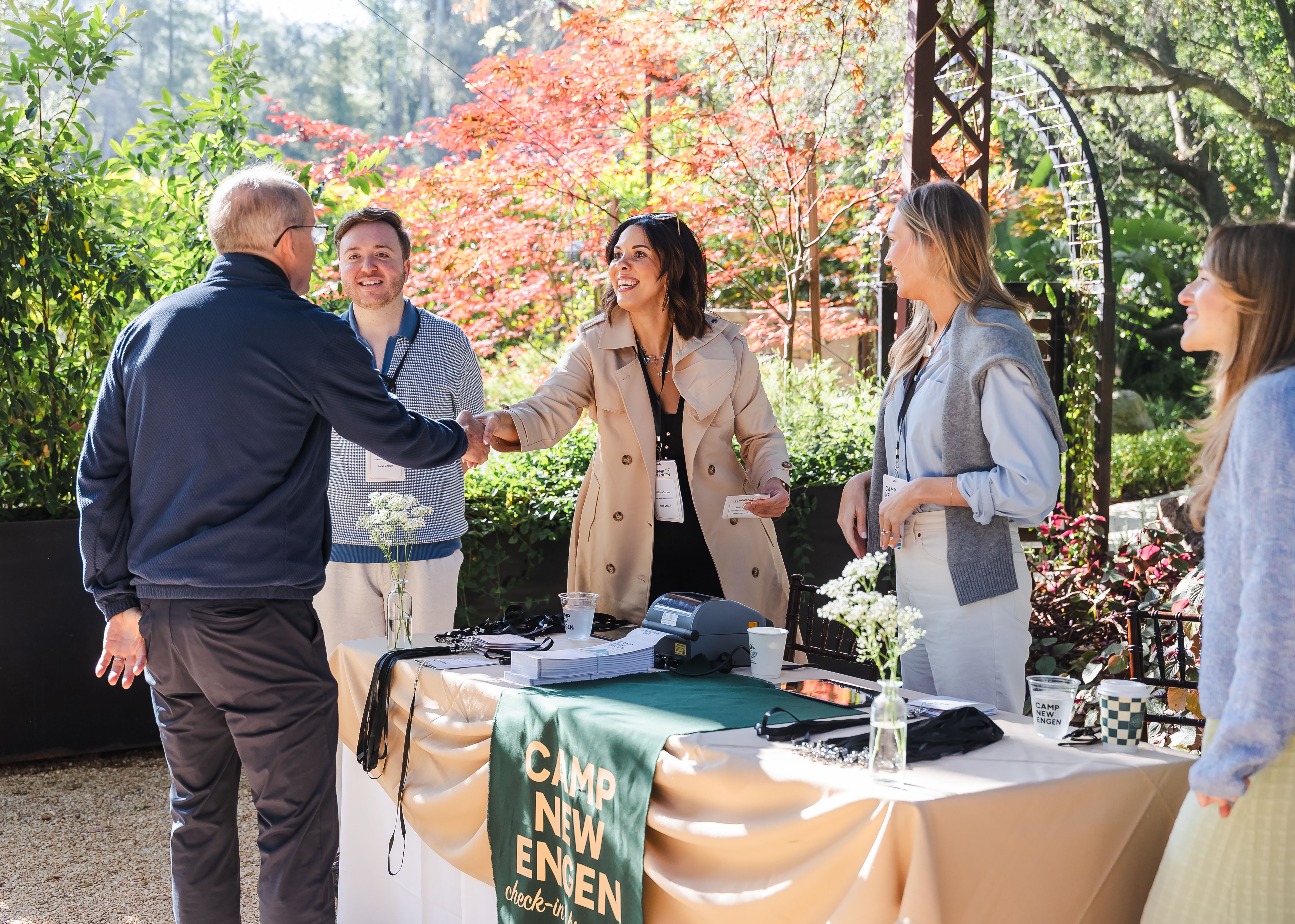 Attendees checking in and greeting each other at the Camp New Engen 2026 marketing summit in Malibu.