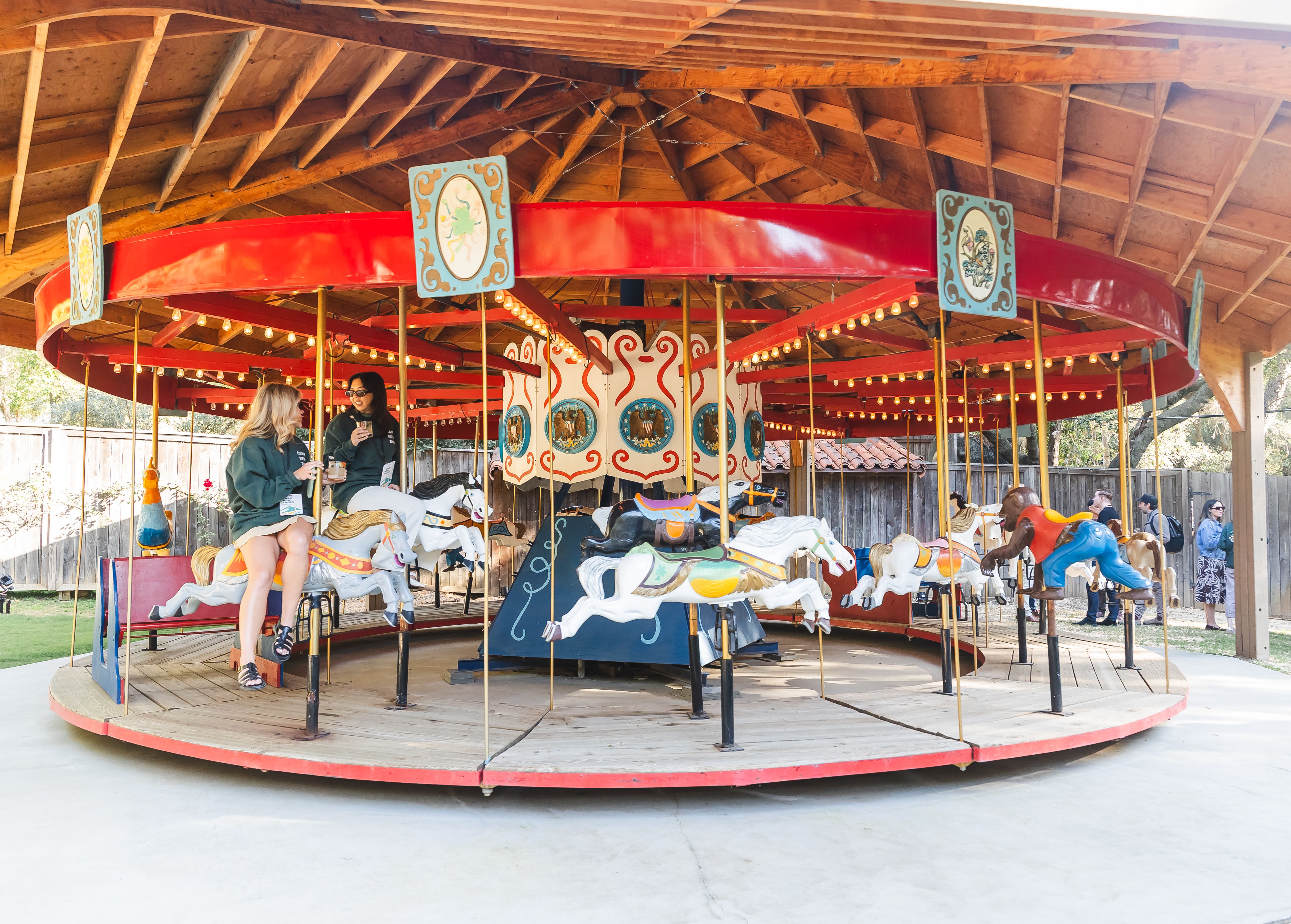 Camp New Engen 2026 attendees talking on a carousel during the retreat-style marketing summit at Calamigos Ranch.