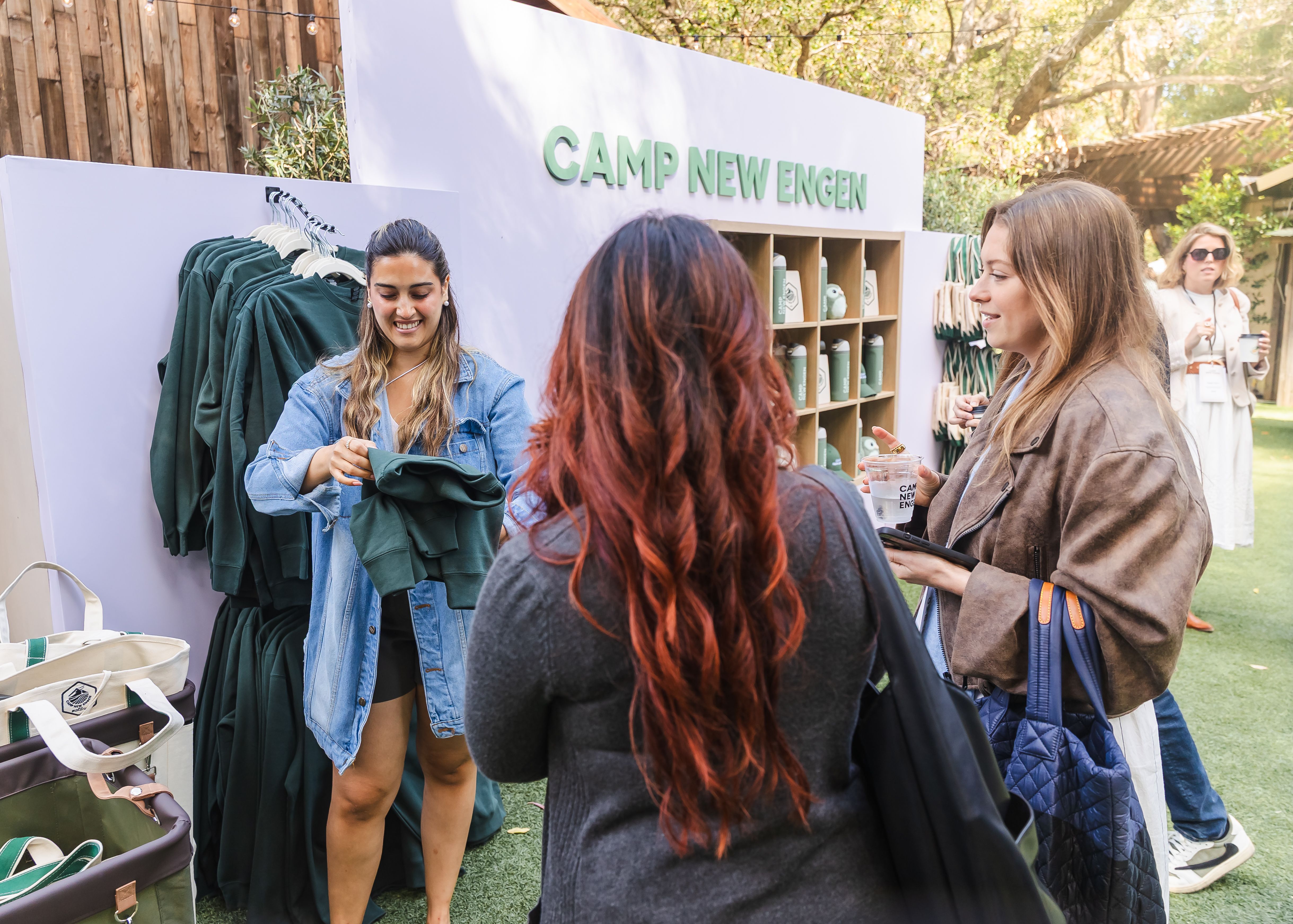 Attendees visit the Camp New Engen 2026 merch station with branded apparel and event gifts at the marketing summit.