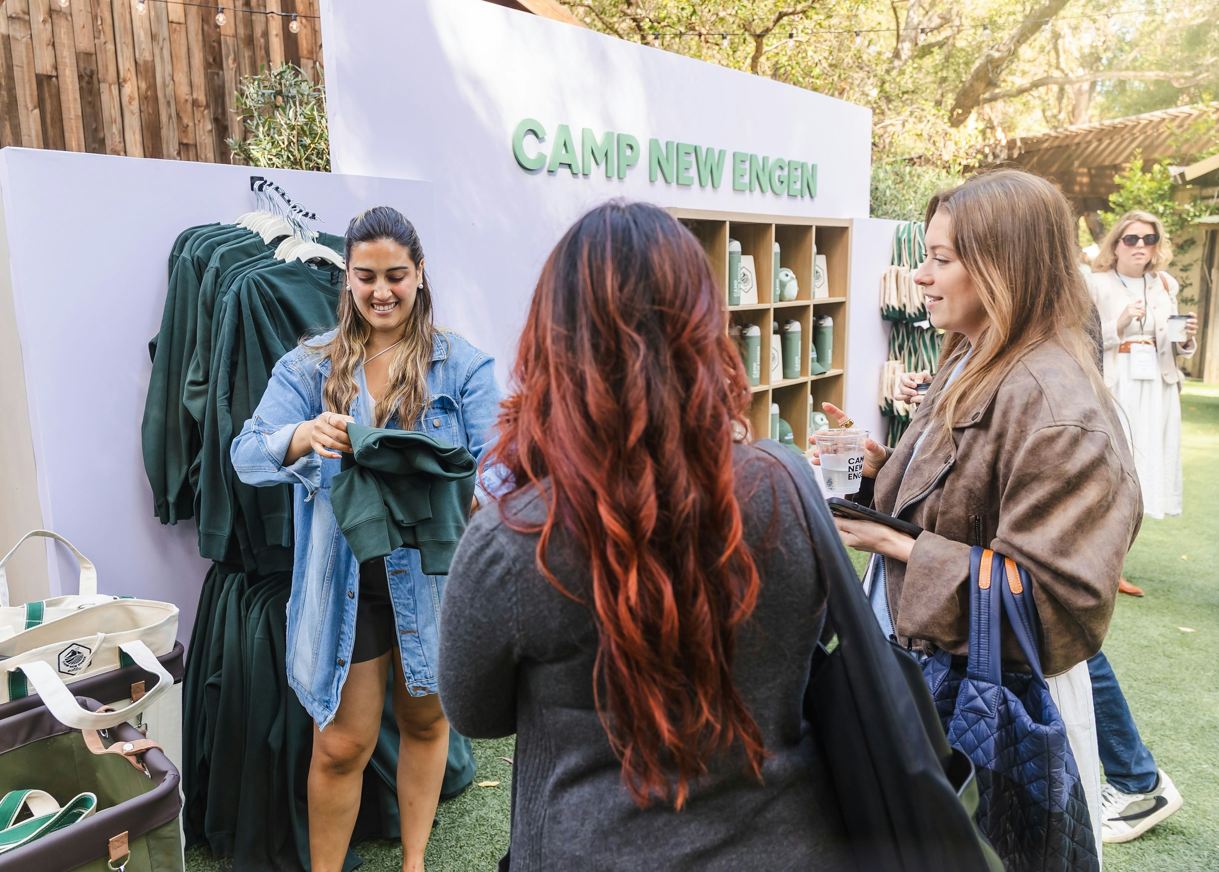 Camp New Engen 2026 Event Merch Station Attendees visit the Camp New Engen 2026 merch station with branded apparel and event gifts at the marketing summit.