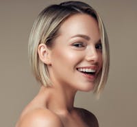 woman with short blonde hair smiling