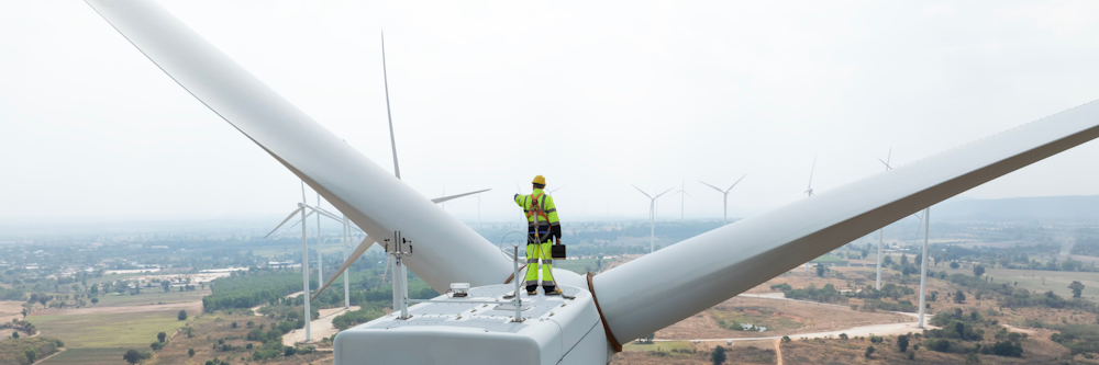 Man standing on wind turbine