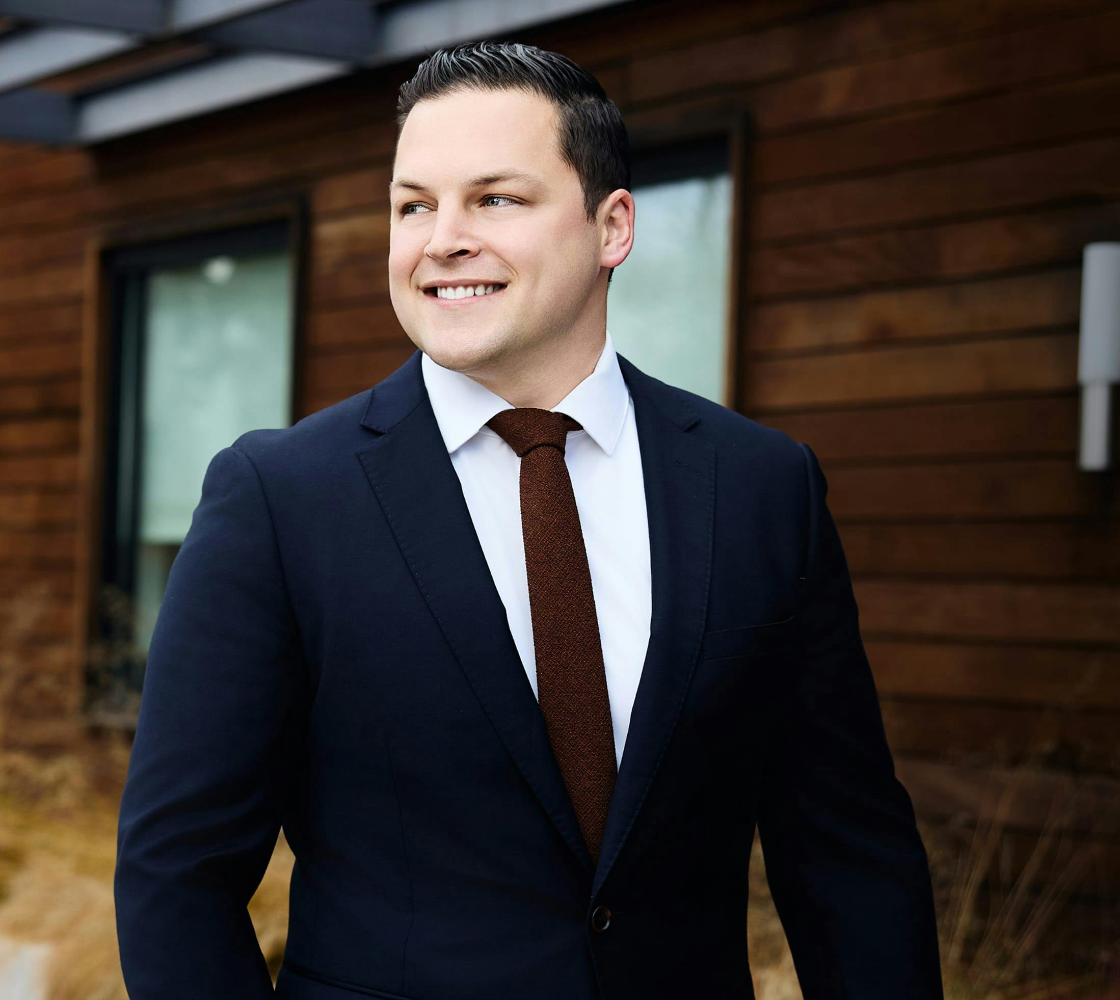 Photo of Dr. Hagen in blue suit and brown tie