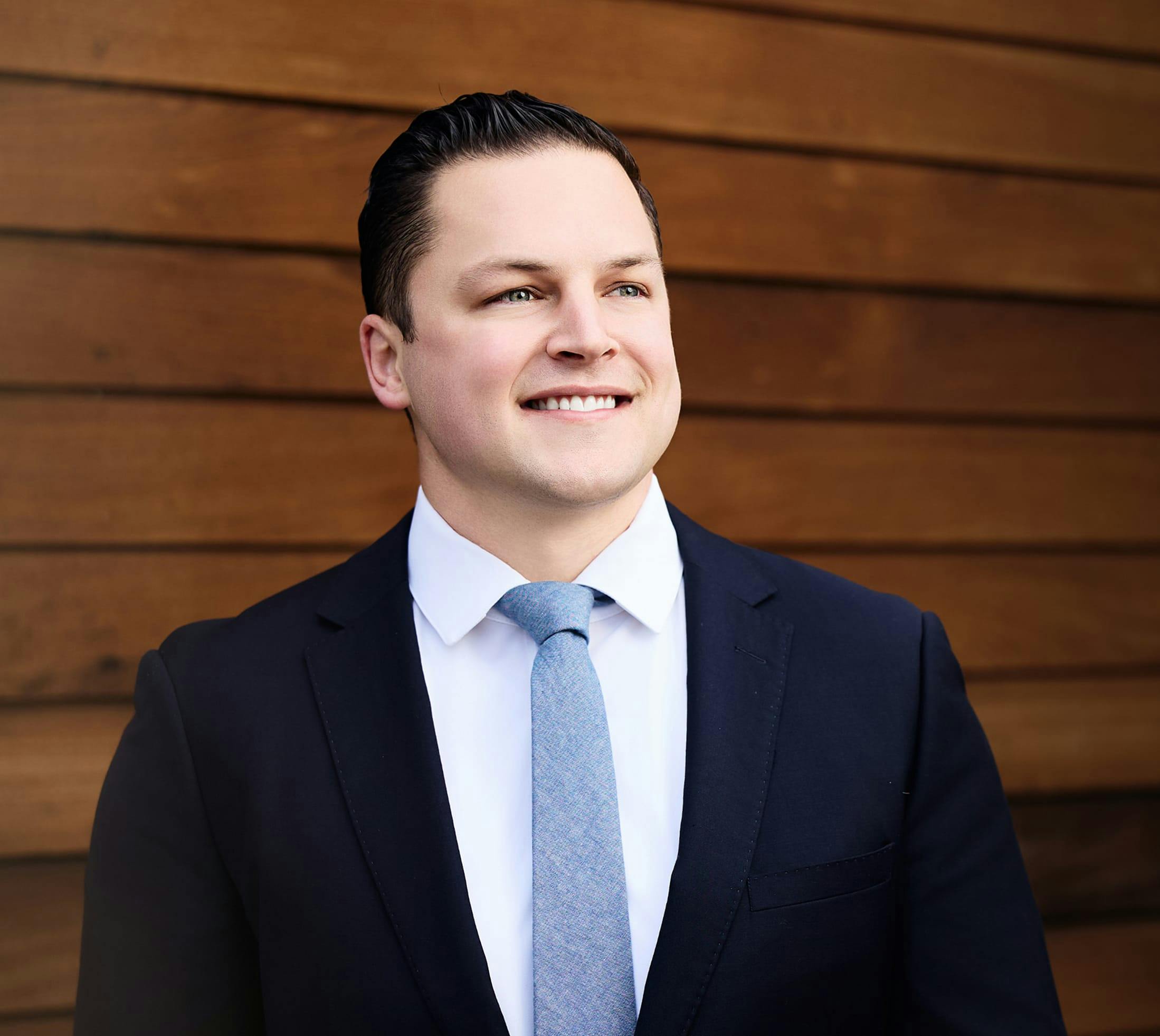 Photo of Dr. Hagen smiling in blue suit and tie