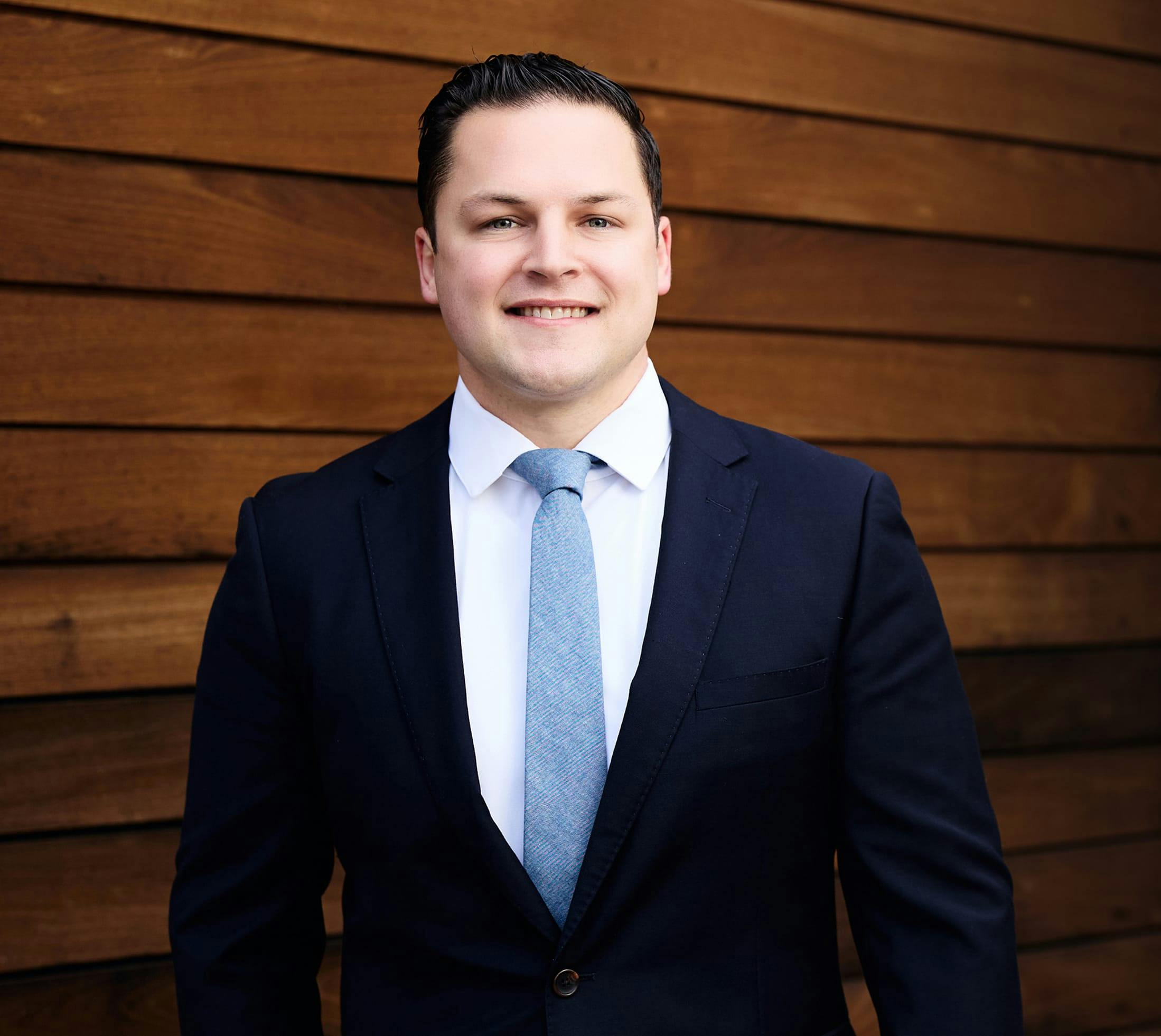 Photo of Dr. Hagen smiling in blue suit and blue tie