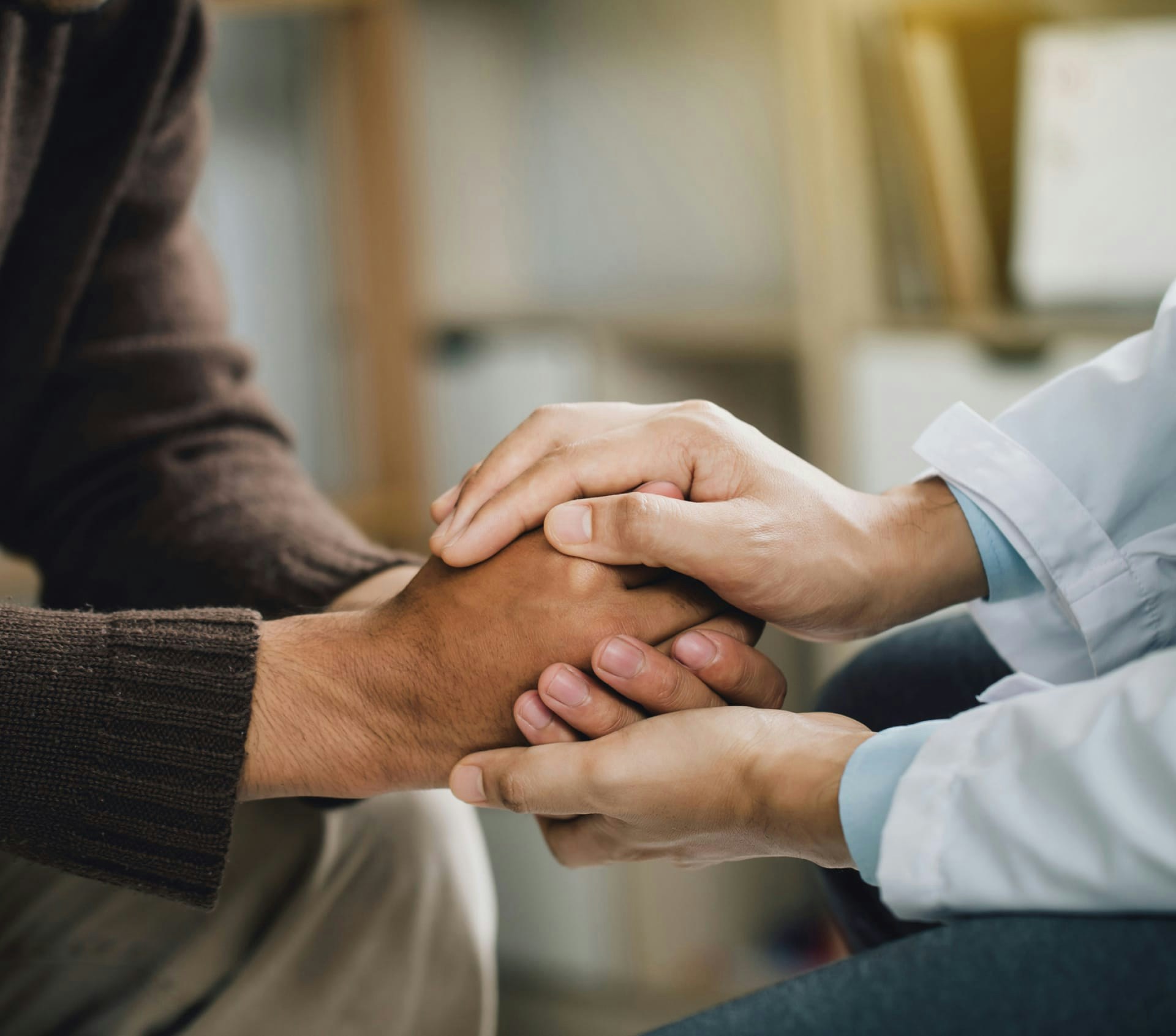 doctor holding a man's hand