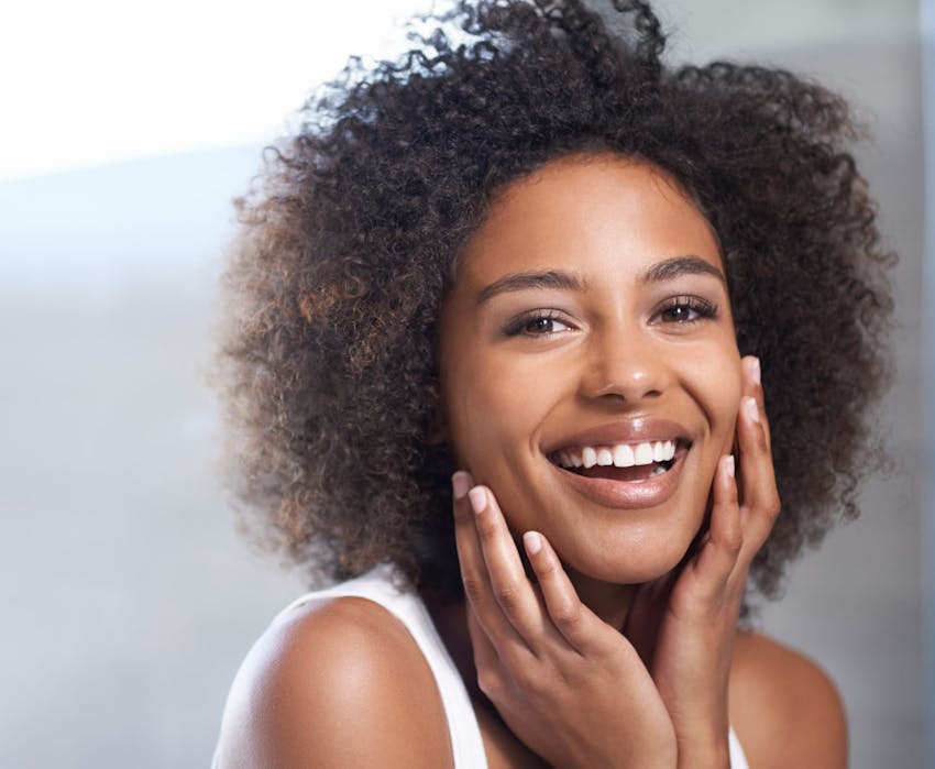 woman touching her face