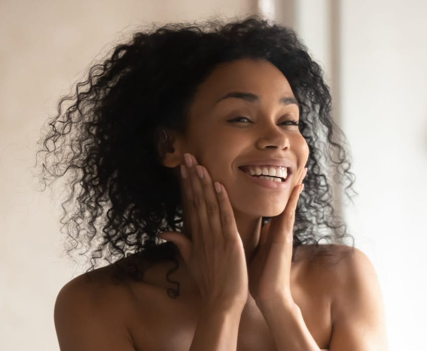 woman touching her cheeks