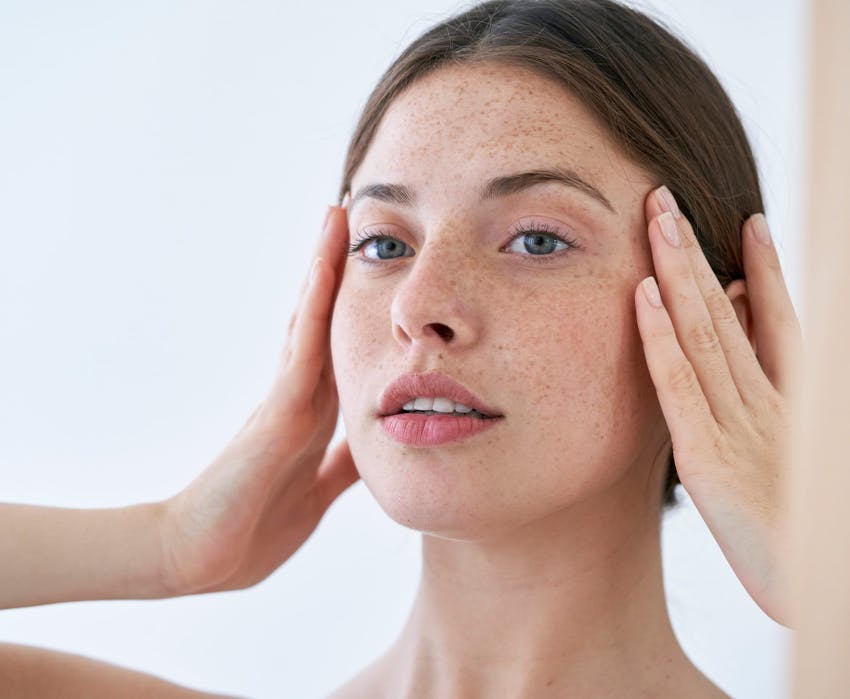 woman touching her face