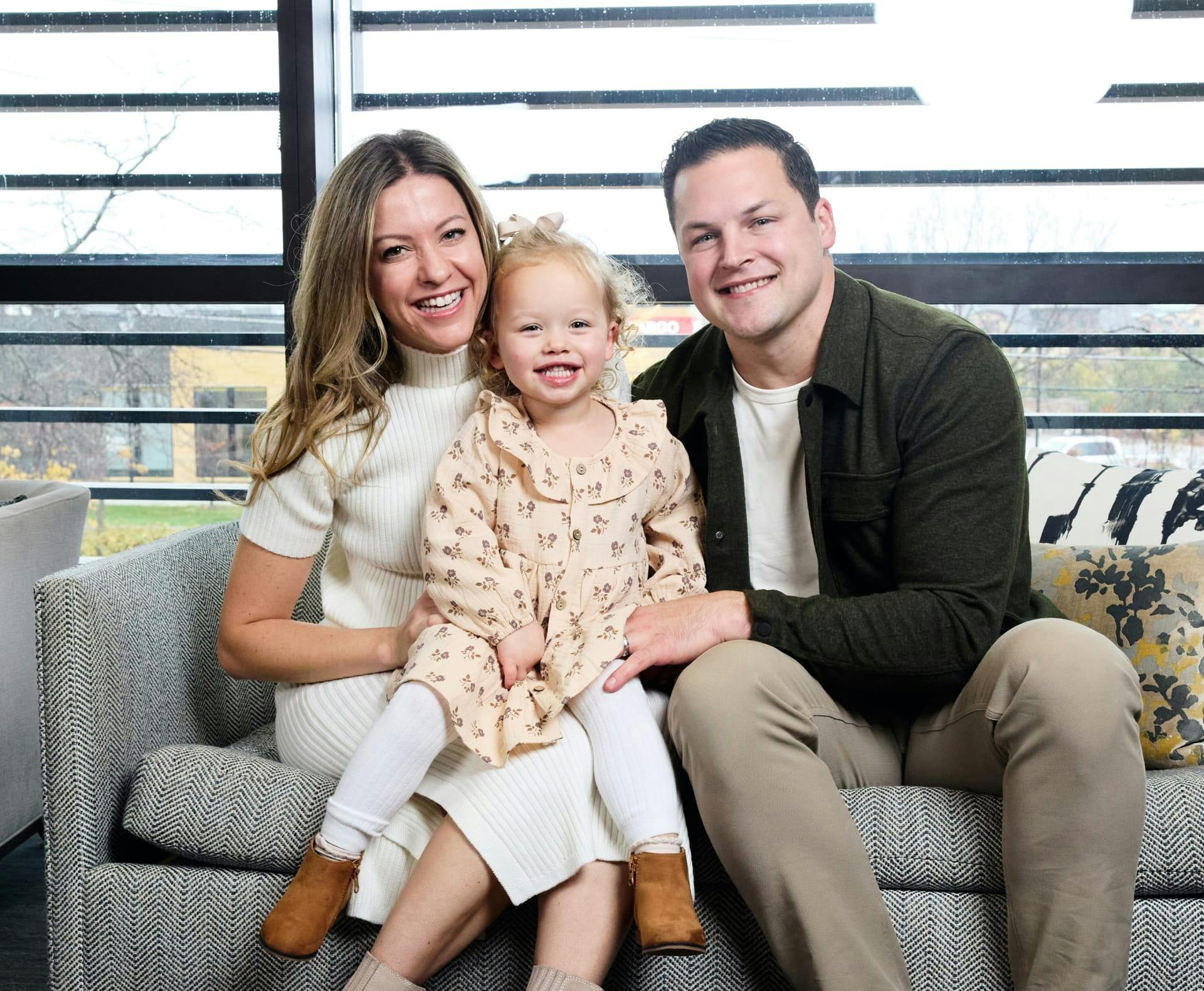 Dr. Hagen sitting with a woman and child