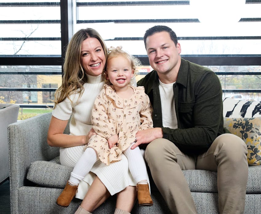 Dr. Hagen sitting with a woman and child