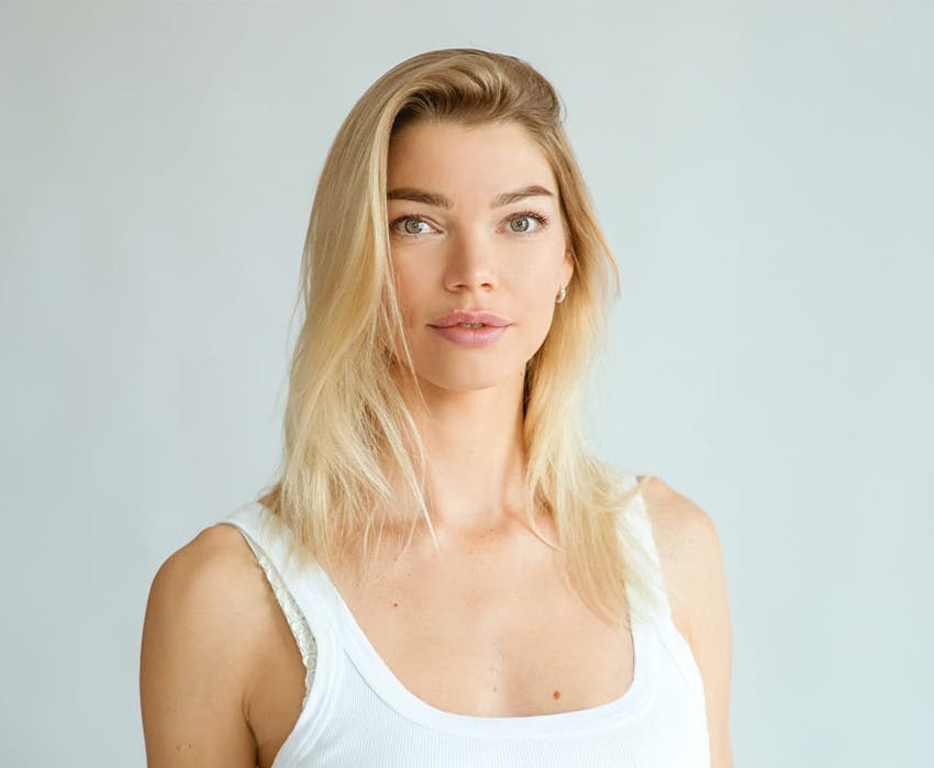 woman with blonde hair wearing a white shirt