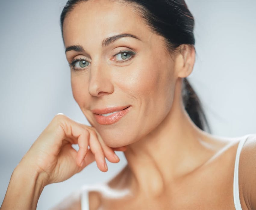 woman resting her lower face on her hand