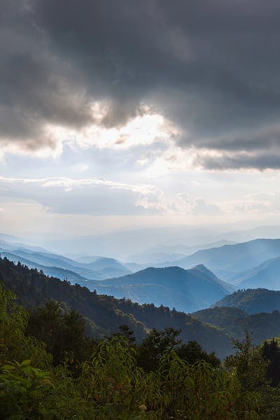 Aesthetic photo of green hills and clouds.