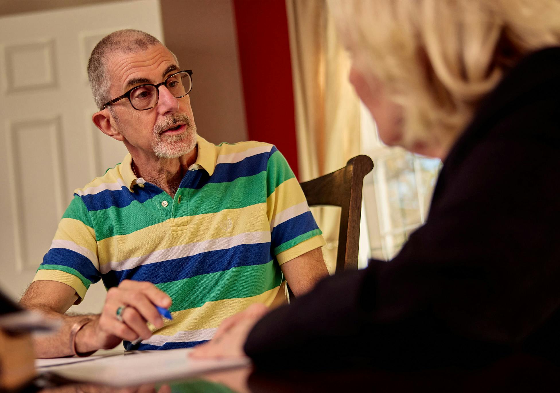 male client sitting and speaking to female attorney