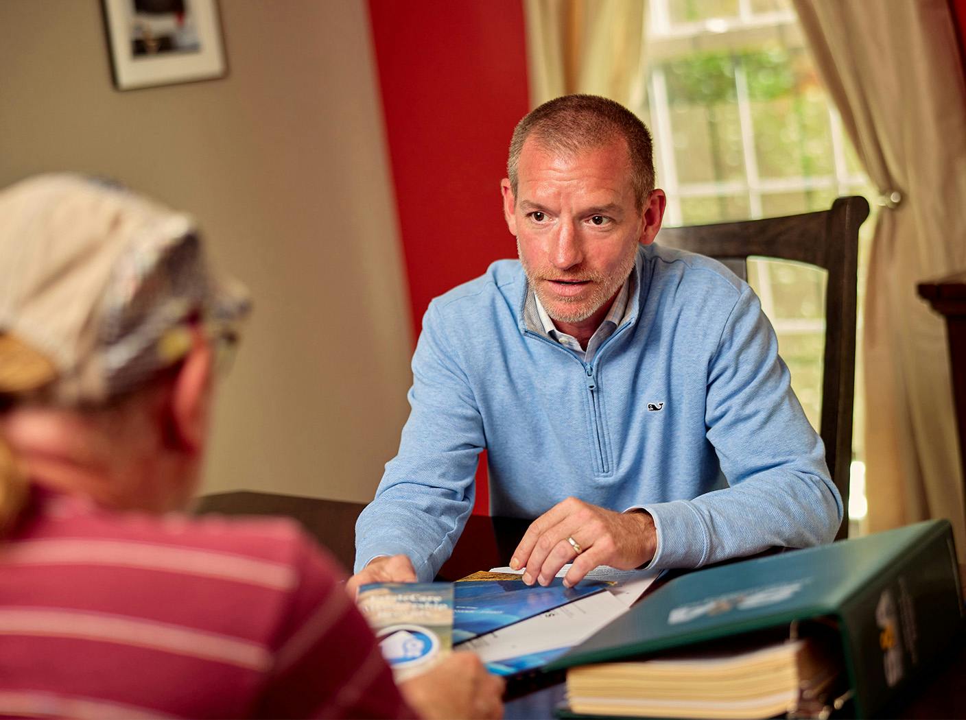male attorney speak to male client at table