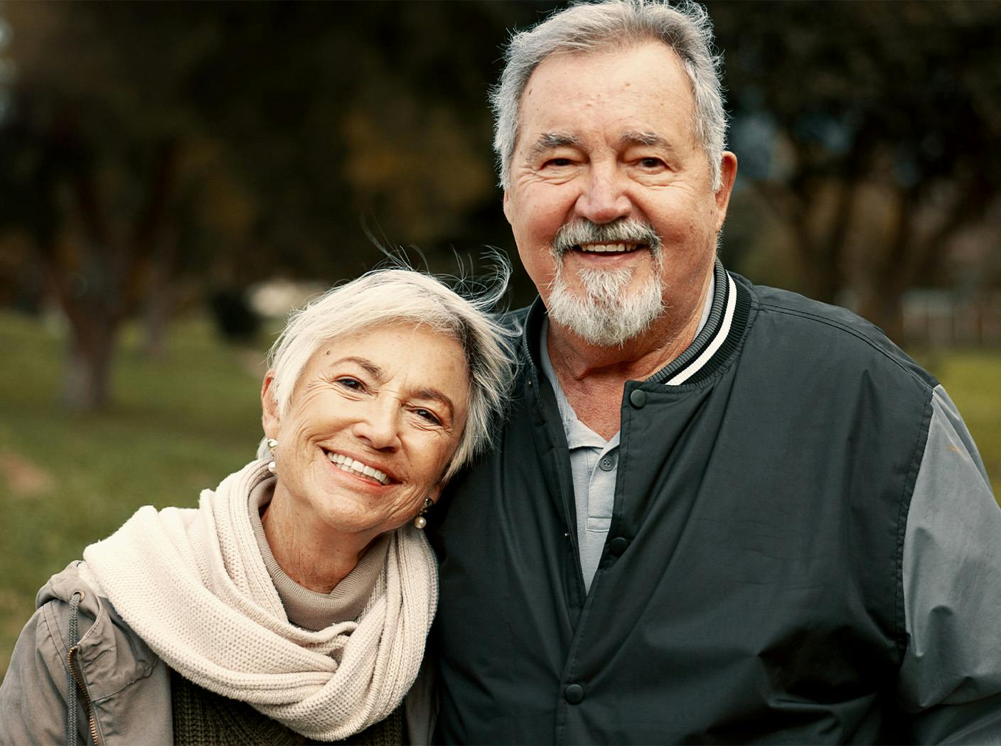 older couple side hugging eachother outside